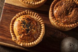 Pies on a chopping board.