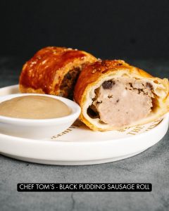 Homemade black pudding sausage roll with home made apple sauce.