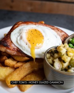 Honey glazed gammon, fried egg and chips with homemade picallili.